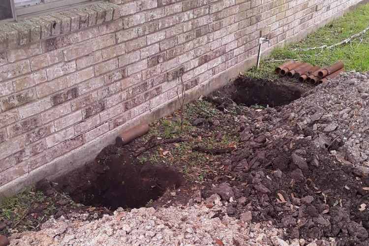 a hole dug for a pier and beam foundation repair in Pflugerville